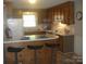Bright kitchen featuring a breakfast bar with seating, wood cabinets and a refrigerator at 146 Barclay Ln, Mooresville, NC 28115