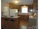 Kitchen featuring wood cabinets, an oven and a breakfast bar that provides seating at 146 Barclay Ln, Mooresville, NC 28115