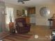 Living room showcasing fireplace, breakfast bar with seating, and open access to the kitchen at 146 Barclay Ln, Mooresville, NC 28115