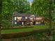 Spacious backyard with multi-level deck and mature trees at 146 Paradise Peninsula Rd, Mooresville, NC 28117