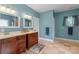 Bathroom with dual sinks, wood cabinets, and ample counter space at 146 Paradise Peninsula Rd, Mooresville, NC 28117