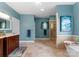 Elegant bathroom with a walk-in shower, soaking tub, double vanity, and tiled floors at 146 Paradise Peninsula Rd, Mooresville, NC 28117