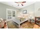 Bedroom featuring a large window, ceiling fan, and a queen-sized bed with plush pillows at 146 Paradise Peninsula Rd, Mooresville, NC 28117
