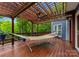 Relaxing outdoor deck with a hammock, pergola, and lush greenery at 146 Paradise Peninsula Rd, Mooresville, NC 28117