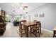 Dining area with a wood table and seating, open to a living room with gray sofa and stone fireplace at 146 Paradise Peninsula Rd, Mooresville, NC 28117