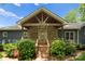Inviting front porch with stone facade, wood columns and a peaked roof at 146 Paradise Peninsula Rd, Mooresville, NC 28117