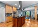 Kitchen island featuring gas cooktop and stainless steel hood with an eat-in dining area at 146 Paradise Peninsula Rd, Mooresville, NC 28117