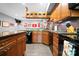 Basement kitchen with granite countertops, wood cabinets, and Ohio State themed decorations at 146 Paradise Peninsula Rd, Mooresville, NC 28117