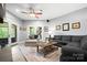 Cozy living room with a gray sofa, chaise lounge, french doors to a deck, and tile flooring at 146 Paradise Peninsula Rd, Mooresville, NC 28117