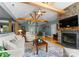 Open concept living room with a brick fireplace, exposed beams, and seamless flow to the foyer at 146 Paradise Peninsula Rd, Mooresville, NC 28117