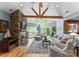 Inviting living room with a brick fireplace, vaulted ceilings, exposed beams, and natural light at 146 Paradise Peninsula Rd, Mooresville, NC 28117