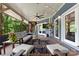 Inviting screened patio featuring a ceiling fan, stylish furniture, and serene wooded views at 146 Paradise Peninsula Rd, Mooresville, NC 28117