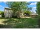 Large backyard with lush green grass and a patio deck, perfect for outdoor activities at 14625 Lyon Hill Ln, Huntersville, NC 28078