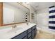 This bathroom features double sinks, framed mirrors, and coordinated blue-and-white decor at 14625 Lyon Hill Ln, Huntersville, NC 28078