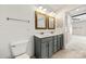Bathroom features double sinks, wood-framed mirrors, updated fixtures, and shiplap wall at 14625 Lyon Hill Ln, Huntersville, NC 28078