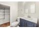 Bathroom with blue vanity, white countertop, and wire shelving in the closet at 14625 Lyon Hill Ln, Huntersville, NC 28078