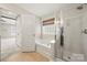 Bathroom featuring a soaking tub, shower, and window at 14625 Lyon Hill Ln, Huntersville, NC 28078