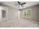 Bedroom featuring neutral walls, carpet, ceiling fan, and a large window at 14625 Lyon Hill Ln, Huntersville, NC 28078
