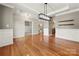 Elegant dining room featuring hardwood floors, wainscoting, and modern light fixtures at 14625 Lyon Hill Ln, Huntersville, NC 28078