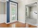 Bright entryway featuring hardwood floors, decorative door, and a view into a carpeted room at 14625 Lyon Hill Ln, Huntersville, NC 28078
