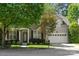 Charming front exterior with a brick facade, well-maintained landscaping, and an attached garage at 14625 Lyon Hill Ln, Huntersville, NC 28078