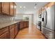 Well-equipped kitchen with wood cabinets, stainless steel appliances, and hardwood flooring at 14625 Lyon Hill Ln, Huntersville, NC 28078