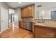 Kitchen with stainless steel dishwasher and granite countertops, next to a door and staircase at 14625 Lyon Hill Ln, Huntersville, NC 28078