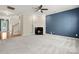Spacious living room with plush carpet, fireplace, ceiling fan, and an open floor plan at 14625 Lyon Hill Ln, Huntersville, NC 28078