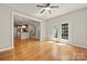 Bright living room features hardwood floors, white trim, ceiling fan, and French doors to the backyard at 14625 Lyon Hill Ln, Huntersville, NC 28078