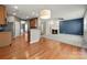 Open-concept living area with a fireplace, hardwood floors, and seamless flow to the kitchen at 14625 Lyon Hill Ln, Huntersville, NC 28078