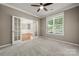 Comfortable office space with carpet, French doors, and a large window for natural light at 14625 Lyon Hill Ln, Huntersville, NC 28078