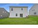 Spacious backyard with healthy lawn and patio doors leading into the home at 151 Astor St, Troutman, NC 28166