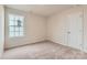 Bright bedroom with neutral carpet and window, featuring an attached closet for easy storage at 151 Astor St, Troutman, NC 28166