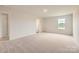 Spacious bedroom featuring neutral carpet, bright natural light, and an attached closet at 151 Astor St, Troutman, NC 28166