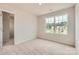 Bedroom with neutral carpet, large window with a neighborhood view, and an attached closet at 151 Astor St, Troutman, NC 28166