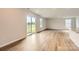 Open-concept living area with hardwood floors, large windows, and sliding door access to outdoor space at 151 Astor St, Troutman, NC 28166