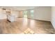 Bright, open-concept living room featuring hardwood floors, large windows, and sliding doors to backyard at 151 Astor St, Troutman, NC 28166