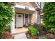Charming townhome entrance with outdoor seating, plants, and a well-maintained front door at 15318 Coventry Court Ln, Charlotte, NC 28277