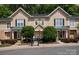 Charming townhome with lush landscaping, complemented by a welcoming entrance and well-maintained facade at 15318 Coventry Court Ln, Charlotte, NC 28277