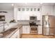 Bright kitchen featuring stainless steel appliances, granite countertops, and modern white cabinets at 15318 Coventry Court Ln, Charlotte, NC 28277