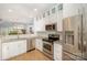 Modern kitchen with stainless steel appliances, granite countertops, and white cabinetry at 15318 Coventry Court Ln, Charlotte, NC 28277