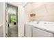 Convenient laundry area features white appliances and shelving for storage, with bedroom view at 15318 Coventry Court Ln, Charlotte, NC 28277