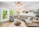 Inviting living room with a large sectional sofa, natural light, and stylish decor at 15318 Coventry Court Ln, Charlotte, NC 28277