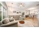 Spacious living room showcases sectional sofa, natural light and is open to the dining area and kitchen at 15318 Coventry Court Ln, Charlotte, NC 28277