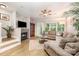 Cozy living room featuring a fireplace, plush seating, and natural light from large windows at 15318 Coventry Court Ln, Charlotte, NC 28277