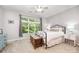 Bright bedroom featuring a large window overlooking a green trees, offering a peaceful and serene atmosphere at 15318 Coventry Court Ln, Charlotte, NC 28277