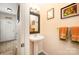 Cozy powder room with pedestal sink, decorative mirror, and stylish wall art at 15318 Coventry Court Ln, Charlotte, NC 28277