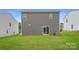Spacious backyard with healthy green grass and a sliding glass door to the house at 155 Astor St, Troutman, NC 28166
