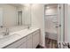Bright bathroom features double sinks, large mirror, and a separate shower/tub room at 155 Astor St, Troutman, NC 28166