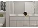 Bright bathroom featuring double sinks, modern fixtures, and neutral color palette at 155 Astor St, Troutman, NC 28166